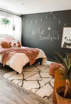 a bedroom with a chalkboard painted on the wall