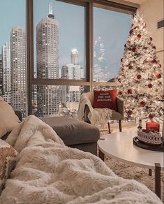 a living room filled with furniture and a christmas tree in front of a large window