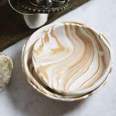 there is a bowl and some rocks on the table