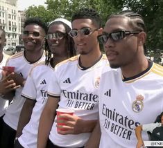 several soccer players are posing for a photo in front of the camera with sunglasses on