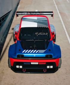 a blue and red sports car is parked on the street