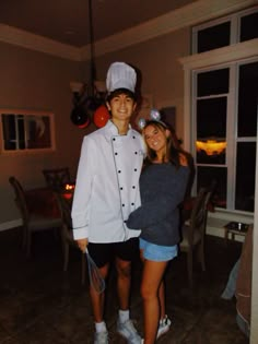 two people dressed up as chefs posing for the camera