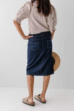 With the look of real denim but the feel of a quality knit, comfort is the key element in our exclusively designed 'Piper 'Skirt. The quick, pull on style with a fabric covered waistband makes this skirt a practical everyday option! Soft, comfortable knit denim fabric Functional Back Pockets 70% Rayon 25% Polyester 5% Spandex Wash Cold Gentle Cycle Hang to Dry Fabric covered elastic waistband Model A Height in Dark Blue 5'5" | Wearing Size Small Wearing 'Finch' Smocked Yoke Cotton Gingham Top in Casual Stretch Denim Skirt With Pockets, Casual Stretch Dark Wash Skirt, Casual Stretch Denim Skirt In Denim Blue, Casual Medium Wash Stretch Skirt, Casual Stretch Denim Skirt, Fall Stretch Medium Wash Skirt, Casual Medium Wash Midi Skirt, Dark Wash Relaxed Skirt For Fall, Casual Medium Wash Denim Skirt With Elastic Waistband