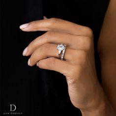 a woman's hand with a diamond ring on it