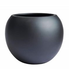 a black vase sitting on top of a white table