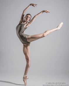 a ballerina in grey leotard and ballet shoes