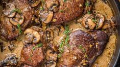 some meat and mushrooms are cooking in a skillet