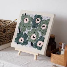 an easel with a crochet pattern on it next to other craft supplies