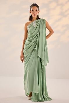 Sage green asymmetric draped one shoulder top embellished by pearl sequin border. Comes with an asymmetric draped skirt and inner bustier. - Aza Fashions Green Top And Skirt, Semi-stitched Draped Blouse Piece With Pallu, Festive Cutdana Embellished Draped Pre-draped Saree, Festive Pre-draped Traditional Draped Skirt, Embellished Semi-stitched Draped Blouse Piece, Luxury Asymmetrical Pre-draped Skirt, Pearl Top, One Shoulder Top, Draped Skirt