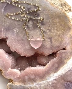 A beautiful heart shaped Rose quartz Crystal has been made into a pendent and placed on a delicate Sterling silver or 14k gold filled chain. 10mmThese rose quartz necklaces are so soft and feminine- with loving calm energy emitting from each stone, and speaking directly to your heart chakra-this will make the perfect addition to you jewelry collection. Handcrafted Raw Rose Quartz Pendant Necklace• Beautiful Raw Crystal jewelry gift • Inspires Love • High quality genuine rose quartz • Raw stones offer stunning unique characteristics• Your choice of chain — sterling silver or 14k gold• Choose the length you’d like — 16, 18, or 20"• Delivered in a luxurious pink velvet jewelry bagUNIQUELY YOURS Your necklace will be made to order and will look similar to the photo above. Because it’s one-of-a