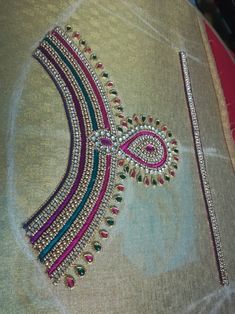 a close up of a piece of cloth with beaded designs and beads on it