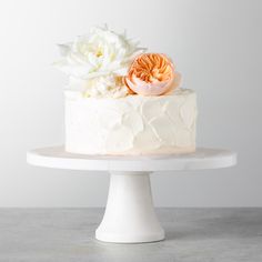 there is a white cake with flowers on top