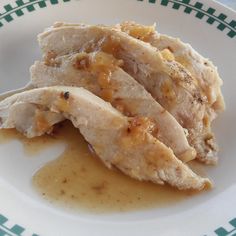 chicken with gravy and sauce on a white plate