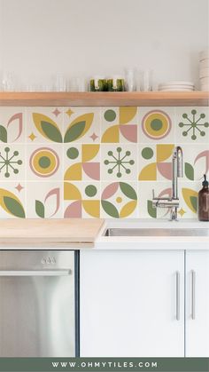 a kitchen with colorful tiles on the wall