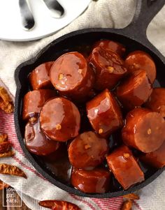 a cast iron skillet filled with cooked sausages