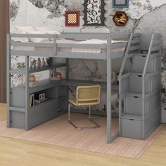 there is a loft bed with stairs to the top and desk below it, in front of a stone wall