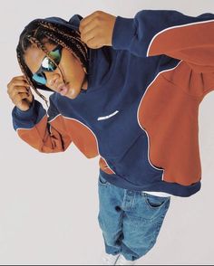 a young boy wearing sunglasses and an orange hoodie