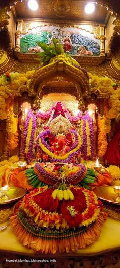 an elaborate arrangement of flowers and fruits on display