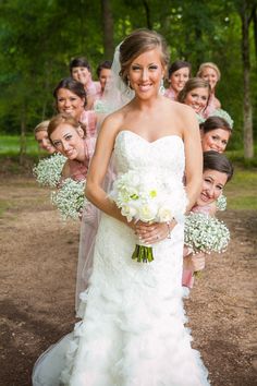 a bride standing in front of her bridal party