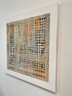 an abstract painting hanging on the wall