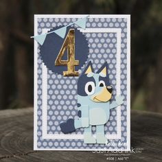 a blue and white birthday card with a cartoon dog on it's face, the number four