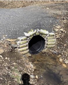 there is a hole in the ground that has been dug into some rocks and gravel