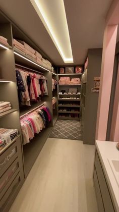 a walk in closet filled with lots of clothes