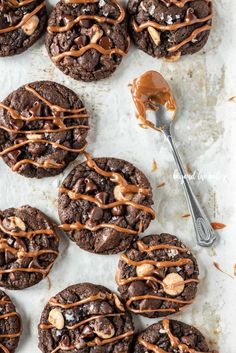 chocolate cookies with peanut butter drizzled on top and spoon in the middle