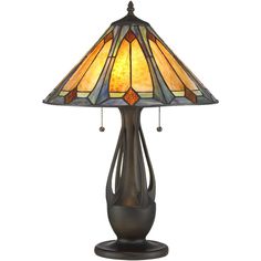 a lamp that is sitting on top of a wooden stand with a stained glass shade