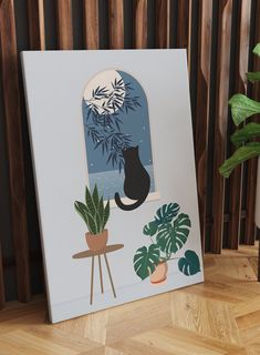 a black cat sitting on top of a wooden table next to a potted plant