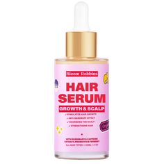 a bottle of hair scrum growth and scalp oil on a white background with a gold cap