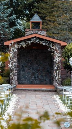 an outdoor ceremony set up with white chairs