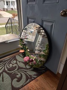 a round mirror sitting on top of a door