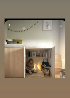 a person sitting on the bottom bunk of a bed in a room with wooden floors