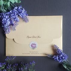 an envelope with purple flowers on it