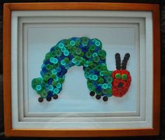 the very hungry caterpillar button art is displayed in a shadow box with buttons