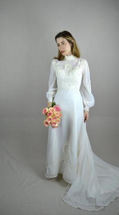 a woman in a white dress holding a bouquet of flowers