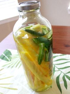 a jar filled with sliced up vegetables on top of a table