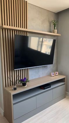 a flat screen tv mounted to the side of a wall