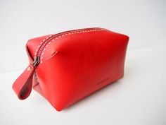 Simple yet unique design zipper pouch.You can carry all of your essential stuffs. - 100% Vegetable tanned leather- Hand stitched with waxed thread- Edges are burnished to smooth sheen- YKK metal zipper- Comes with 100% cotton bagApproximate Dimensions: W 6.25" x H 3.50" x D 2.75'' W 16cm x H 9cm x D 7cmZipper length:  8"20cmPersonalisation (optional)- Complimentary personalisation is available.- You can chose up to 6 letters (capital alphabet only (6mm height). include 'space' and 'dots')- Pleas Leather Makeup Pouch, Leather Zipper Pouch, Leather Zip Pouch, Leather Cosmetic Bag, Leather Makeup Bag, Leather Key Holder, Leather Key Case, Vanity Bag, Leather Keyring