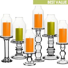 candles are lined up in glass vases with orange and green candle holders on them