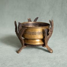 an old brass cup with two birds on it