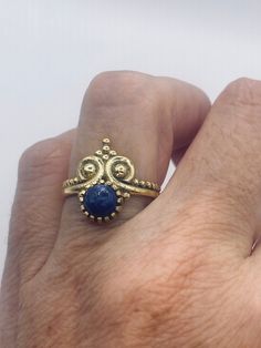 Blue lapis lazuli cocktail ring  Lovely vintage golden bronze setting Size 6 or 7 Our jeweler can custom re size this for a $20 fee.  All rings are shipped in a nice gift box.   Check out our over a THOUSAND great reviews Engraving is $4 per letter and is not always perfect depending on the piece. It can take a few days if the jeweler is busy. This is payable to Paypal Judithsltd@gmail.com Blue Brass Ring Jewelry, Royal Gold Jewelry Gift, Royal Gold Jewelry As A Gift, Royal Gold Jewelry For Gift, Vintage Lapis Lazuli Jewelry For Gifts, Vintage Lapis Lazuli Jewelry As A Gift, Vintage Lapis Lazuli Jewelry As Gift, Adjustable Blue Brass Ring, Unique Gold Jewelry With Lapis Lazuli