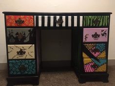 this is an image of a desk made out of different colored drawers and handles on it