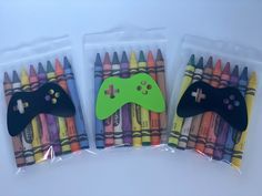 three bags of crayons with two video game controllers on them