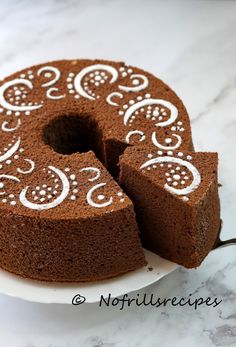 there is a chocolate cake with white designs on it