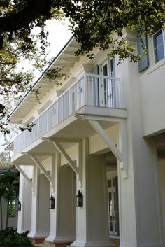 an apartment building with balconies on the second floor