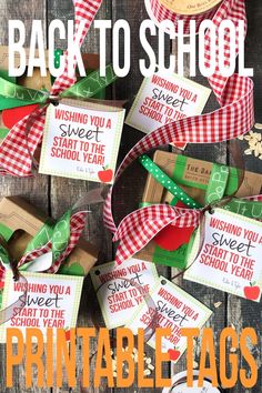 the back to school printable tags are laid out on a wooden table with ribbon