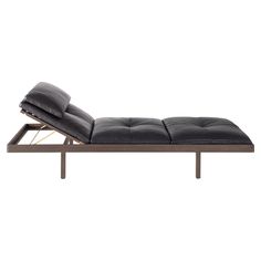 a black leather chaise lounge chair with metal frame and footrests on an isolated white background