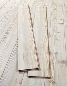 two pieces of wood sitting on top of a wooden floor